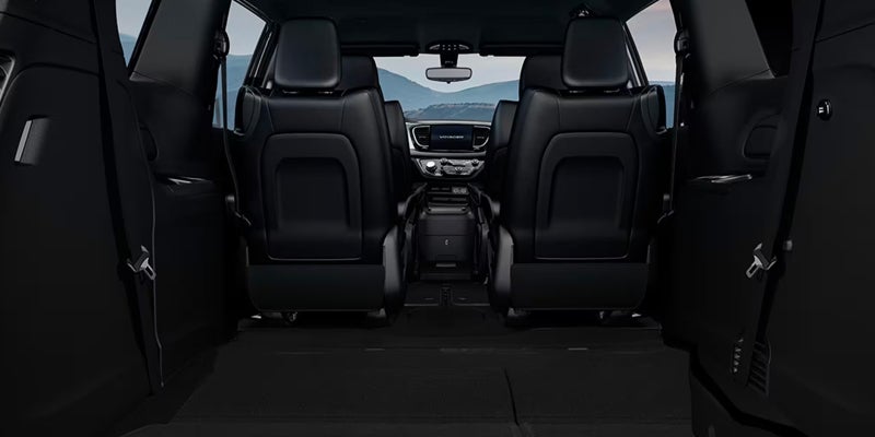 Rear cargo area of a Chrysler minivan with seats folded flat, demonstrating expanded storage capacity and flexible interior configuration