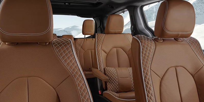Premium Chrysler Pacifica interior featuring quilted tan leather seats across multiple seating rows