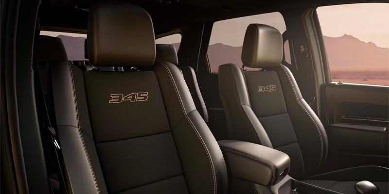 Front cabin of a Dodge Durango featuring black leather seats embroidered
