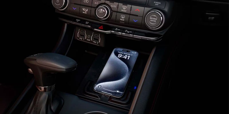 Center console of a Dodge Durango featuring a wireless smartphone charging pad, gear selector