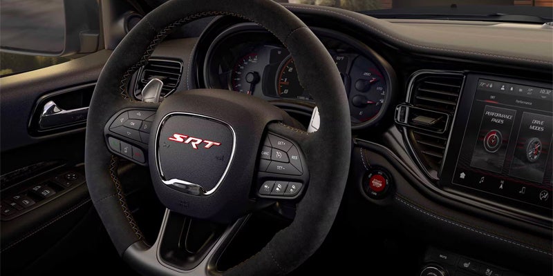 Driver-focused Dodge Durango SRT interior with a performance steering wheel, digital gauge cluster