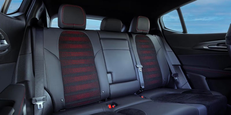 Rear passenger seating area of the Dodge Hornet featuring black seats with red accent inserts and contrast stitching.