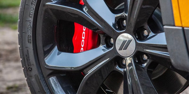Close-up of a Dodge Hornet alloy wheel showcasing the wheel design and red brake caliper.