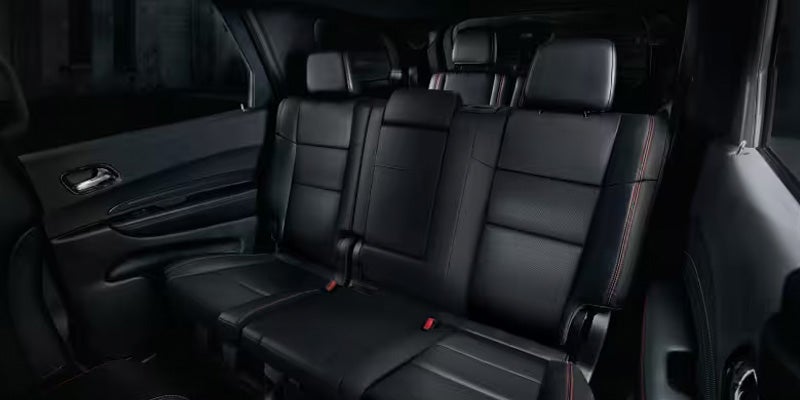 Interior view of the Dodge Durango showing black leather third-row seating with room for multiple passengers.