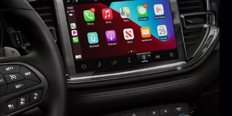 Close-up of the Dodge Durango infotainment touchscreen displaying smartphone connectivity and vehicle interface controls.