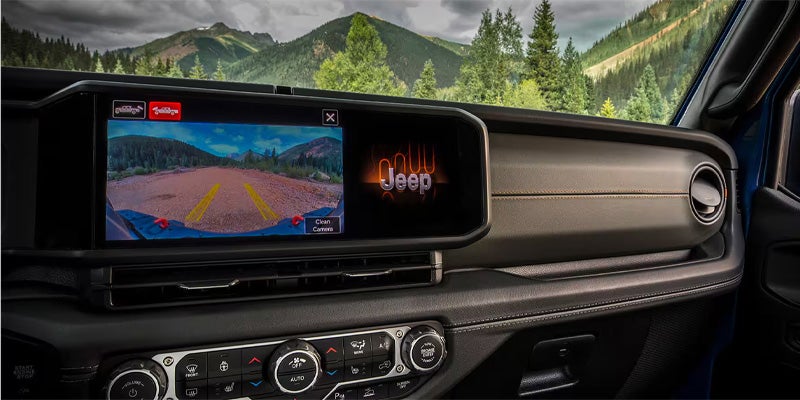 Jeep Gladiator dashboard featuring a widescreen infotainment display showing an off-road camera view