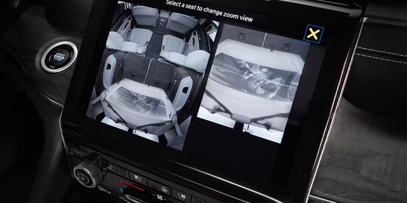 Infotainment screen displays an overhead view of a car's interior with 3 baby seats, and a close-up of one.