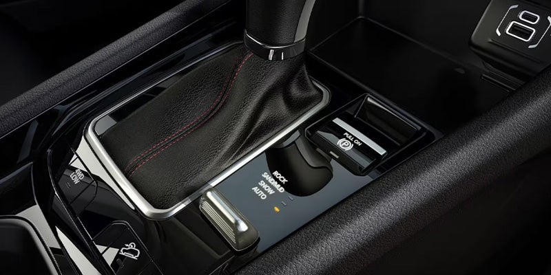 Close-up of the Jeep Compass center console featuring the gear shifter