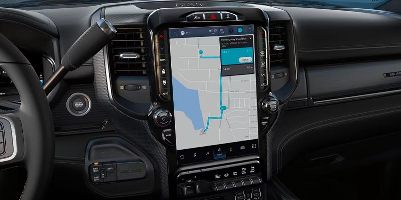 Interior view of a car dashboard with a large central touchscreen displaying a GPS map and navigation route.