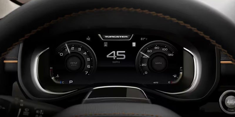Dashboard display showing "45 MPH" centrally, with analog RPM and MPH gauges on either side, and "TUNGSTEN" at the top.
